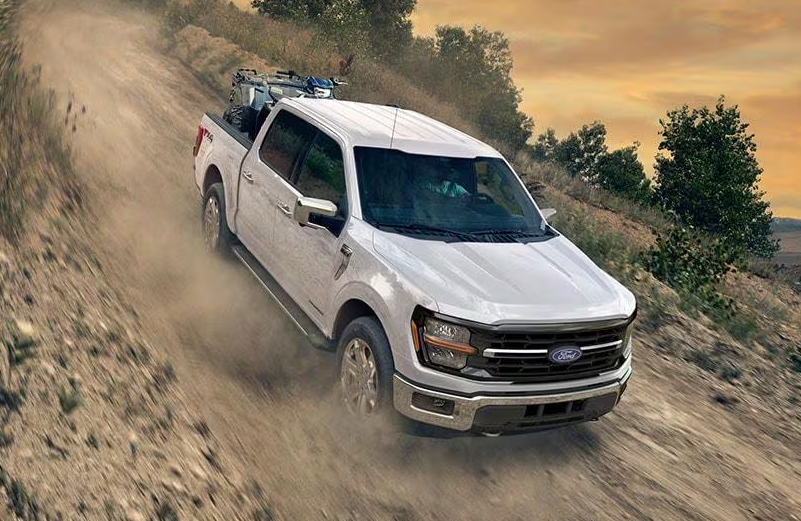 White 2026 Ford F-150 driving off-road