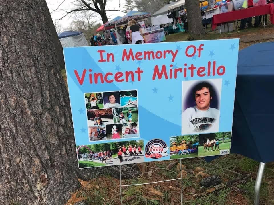 Memorial sign with photos honoring Vincent Miritello.
